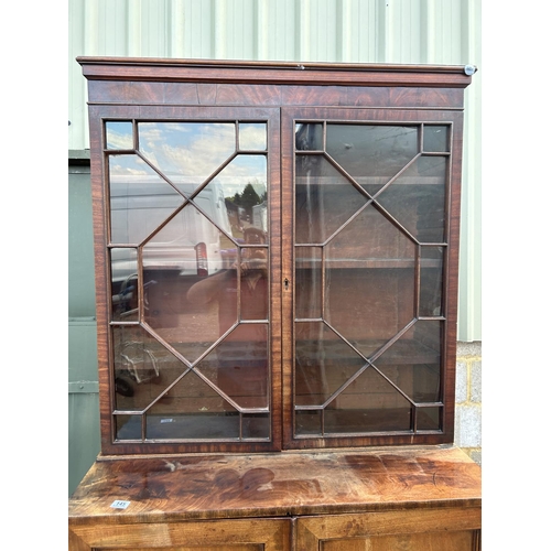 145 - A early victorian mahogany glazed bookcase cupboard  104x53x220