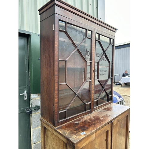 145 - A early victorian mahogany glazed bookcase cupboard  104x53x220