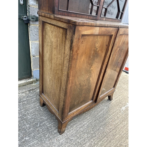 145 - A early victorian mahogany glazed bookcase cupboard  104x53x220