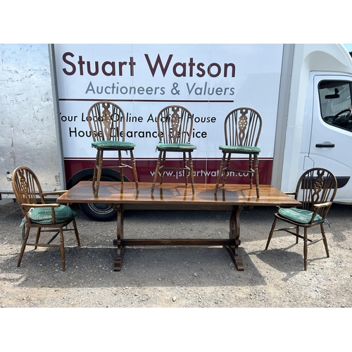 148 - A long oak refectory style dining table together with five wheelback chairs  230x75x74