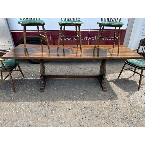 148 - A long oak refectory style dining table together with five wheelback chairs  230x75x74