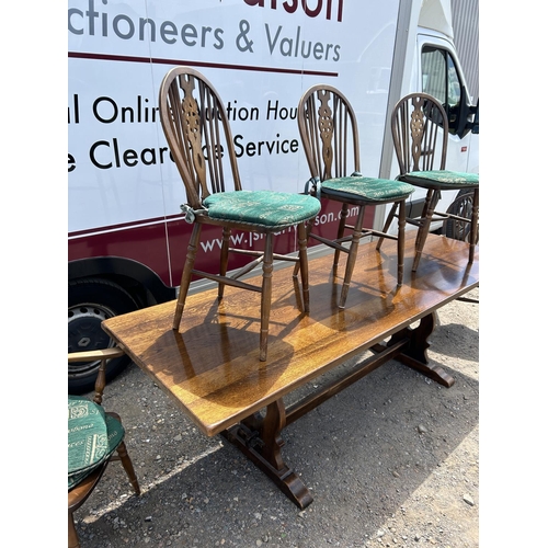 148 - A long oak refectory style dining table together with five wheelback chairs  230x75x74