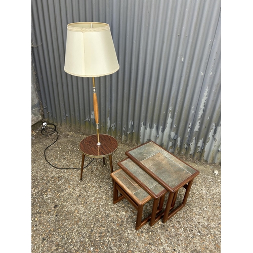 160n - A retro lamp together with a teak nest of three