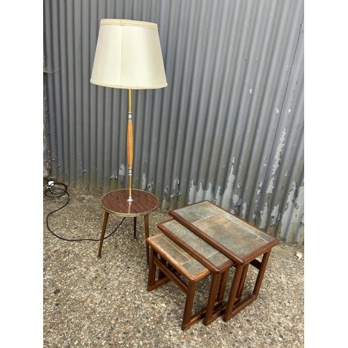 160n - A retro lamp together with a teak nest of three