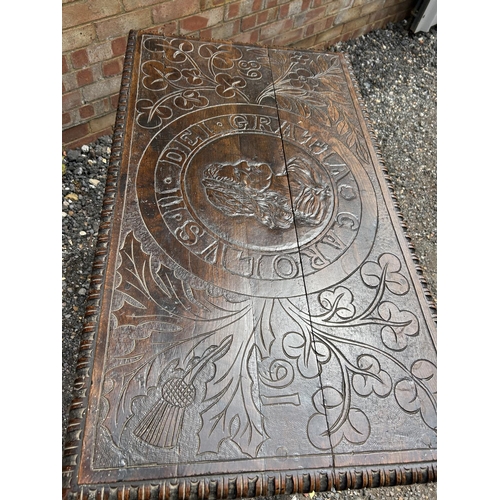 18 - An early carved oak centre table carved with a face to the top and marked 1668 110x62 x75