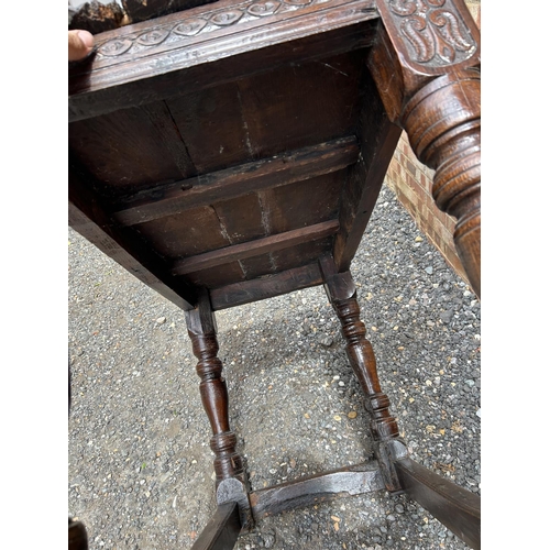 18 - An early carved oak centre table carved with a face to the top and marked 1668 110x62 x75