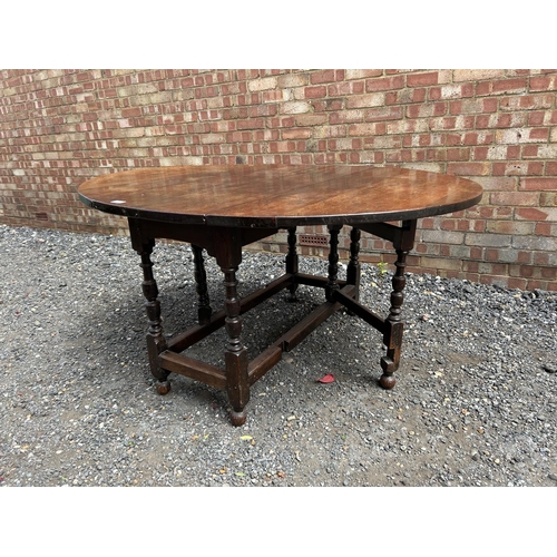 27 - An early oak gate leg dining  table 126 cm long