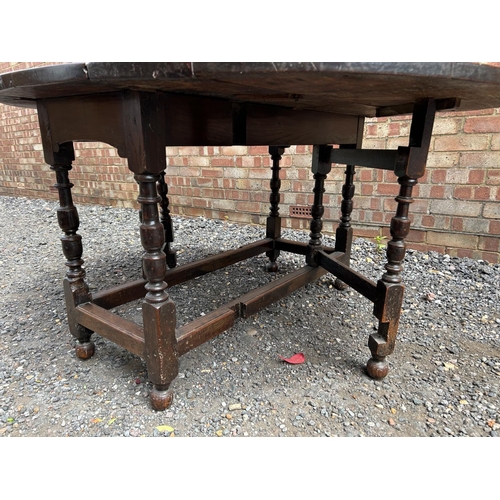 27 - An early oak gate leg dining  table 126 cm long