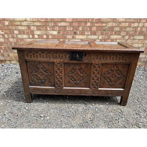 31 - A carved oak three panel blanket box chest 130x57x70