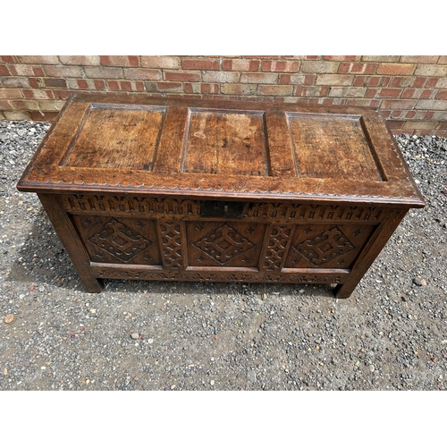 31 - A carved oak three panel blanket box chest 130x57x70