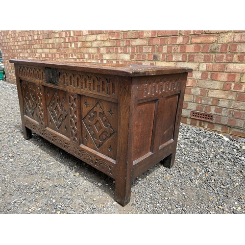 31 - A carved oak three panel blanket box chest 130x57x70