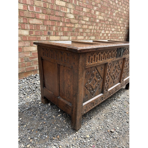 31 - A carved oak three panel blanket box chest 130x57x70