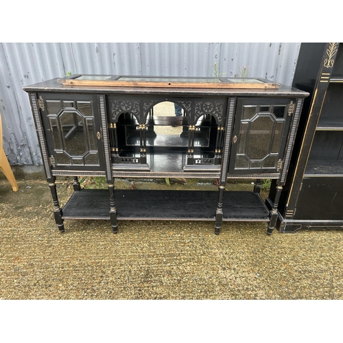 356 - An ebonised sideboard together with matching bookcase