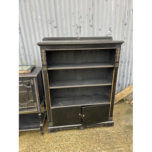 356 - An ebonised sideboard together with matching bookcase