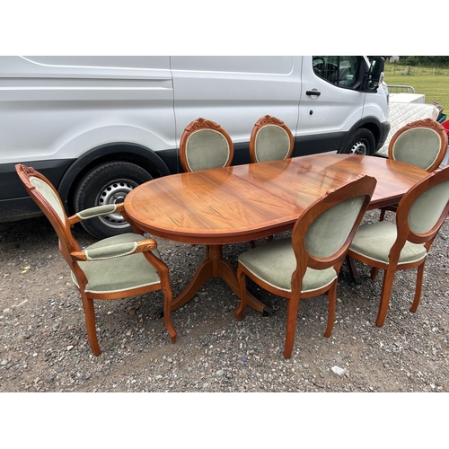 45 - A reproduction yew wood twin pedestal dining table with extension leaf and set of six matching chair... 