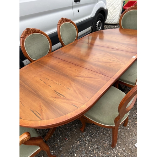 45 - A reproduction yew wood twin pedestal dining table with extension leaf and set of six matching chair... 