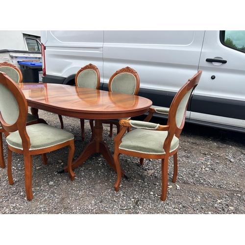 45 - A reproduction yew wood twin pedestal dining table with extension leaf and set of six matching chair... 