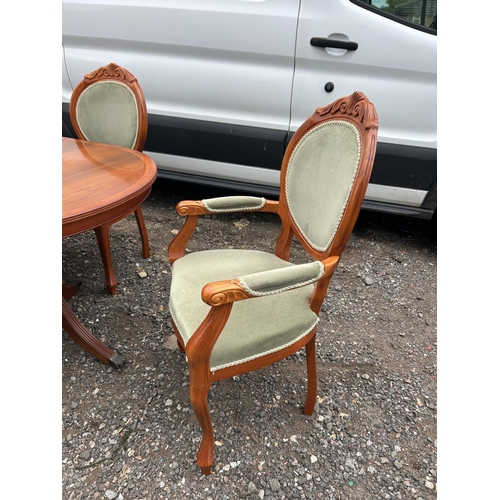 45 - A reproduction yew wood twin pedestal dining table with extension leaf and set of six matching chair... 