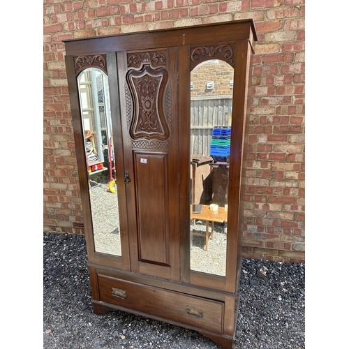 6 - A double door mahogany wardrobe with carved panel to the front  104x44x190