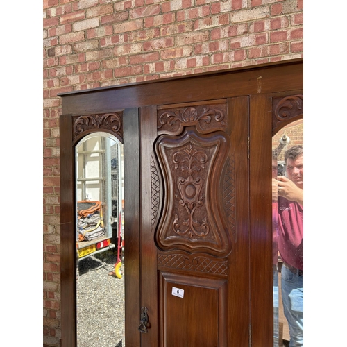 6 - A double door mahogany wardrobe with carved panel to the front  104x44x190