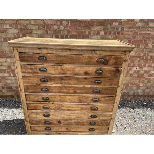 62 - A large pine architects plan chest of 10 drawers with cup handles 127x53x145