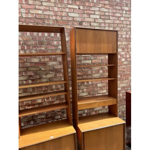 69 - A set of three g plan teak sectional bookcases, two with shelves and sliding door bases, one with fo... 