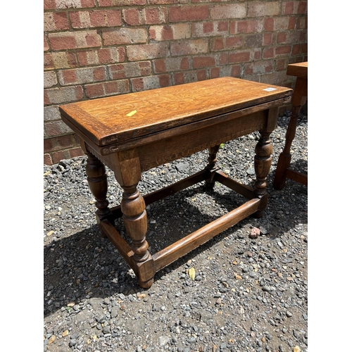 73 - Two oak occasional tables with twist and flip over tops