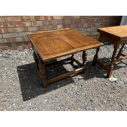 73 - Two oak occasional tables with twist and flip over tops