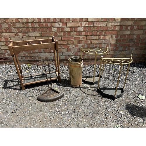 79 - An oak hallstand together with four brass stick stands