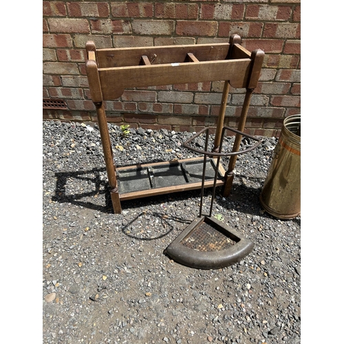 79 - An oak hallstand together with four brass stick stands