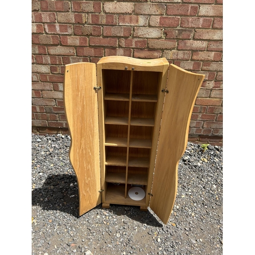 80 - A modern light oak storage cupboard