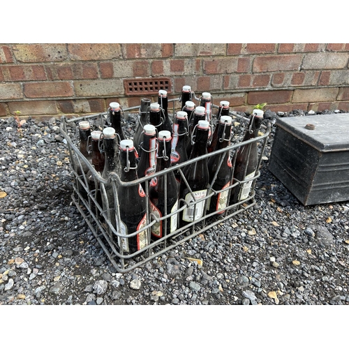 9 - A large tin trunk, two wooden tool boxes and a vintage beer crate with bottles