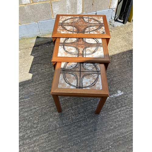 98 - A danish teak tile top nest of three tables marked TRIOH