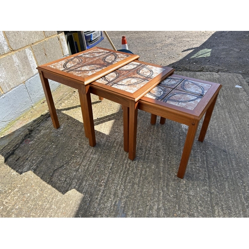 98 - A danish teak tile top nest of three tables marked TRIOH