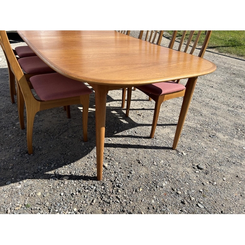 99 - A danish teak extending dining tabke by DANSK together with two leaves and a set of 6 chairs (max si... 