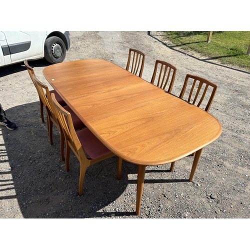 99 - A danish teak extending dining tabke by DANSK together with two leaves and a set of 6 chairs (max si... 