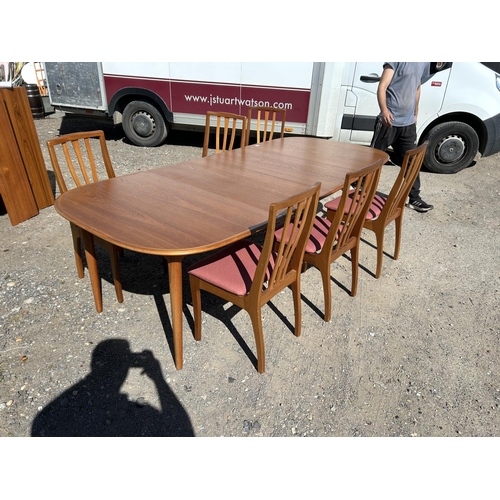 99 - A danish teak extending dining tabke by DANSK together with two leaves and a set of 6 chairs (max si... 