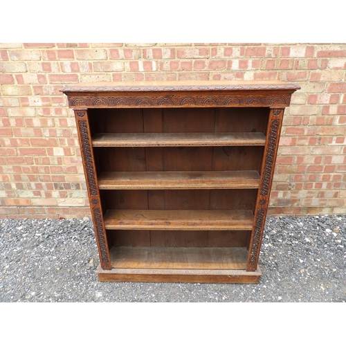 1 - A carved oak open fronted bookcase with three open shelves 104x23x118