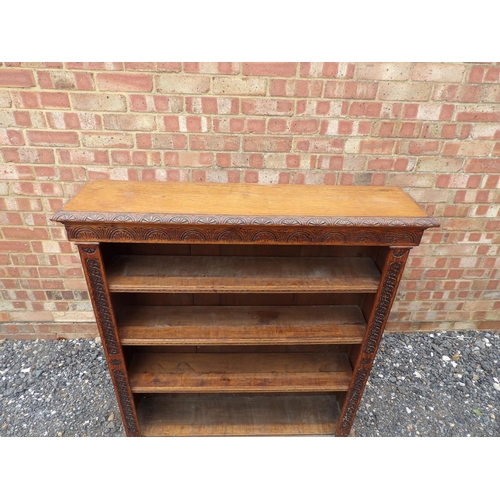 1 - A carved oak open fronted bookcase with three open shelves 104x23x118