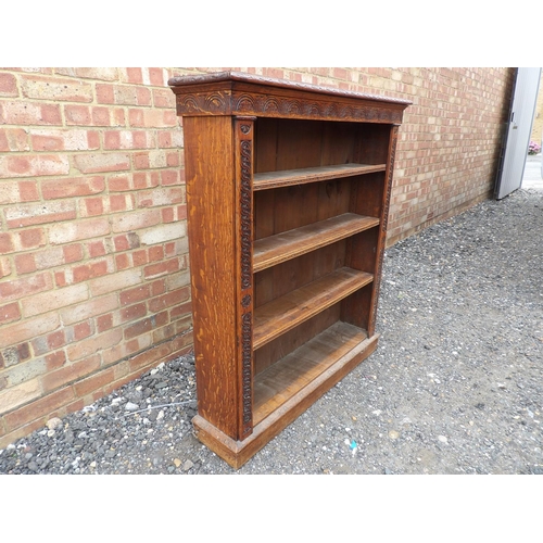 1 - A carved oak open fronted bookcase with three open shelves 104x23x118