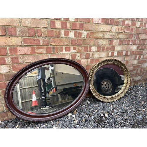 10 - Two large oval wall hanging mirrors