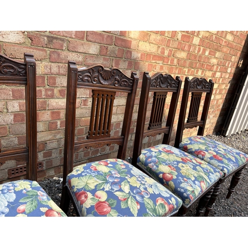 100e - A set of four Edwardian dining chairs with blue floral upholstered seats