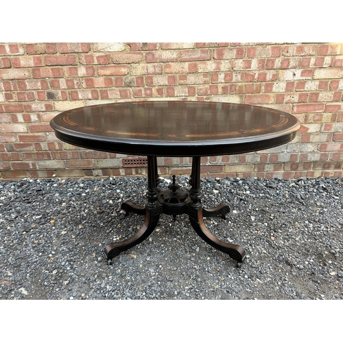 100i - A ebonised walnut oval breakfast table 116x77x70