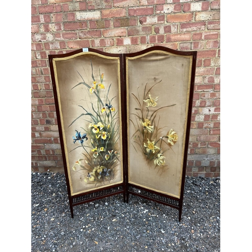 100n - A mahogany two section screen with floral painted on fabric panels 140cm tall