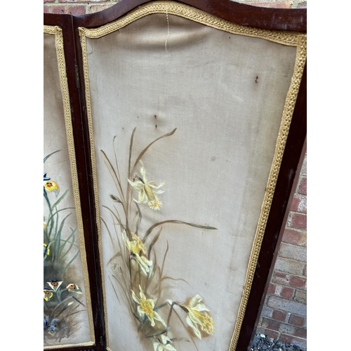 100n - A mahogany two section screen with floral painted on fabric panels 140cm tall