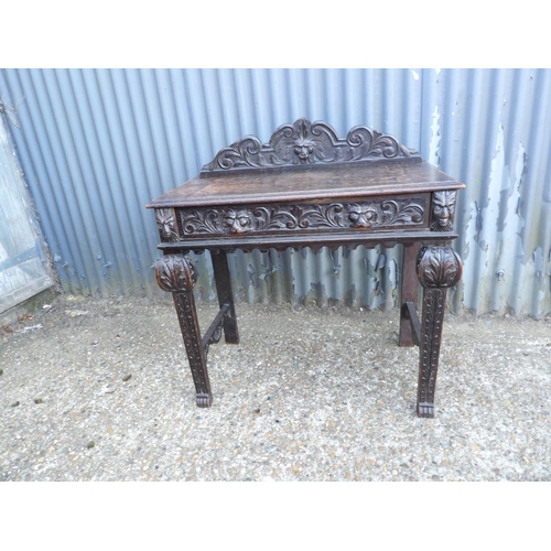 112 - A carved oak single drawer table 88x44x77