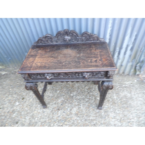 112 - A carved oak single drawer table 88x44x77