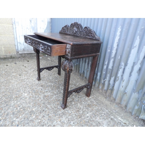 112 - A carved oak single drawer table 88x44x77