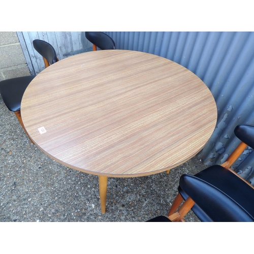 120 - A circular formica kitchen table together with four schrieber teak dining chairs