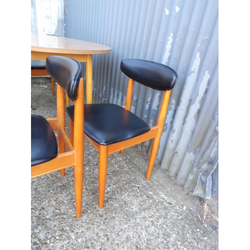 120 - A circular formica kitchen table together with four schrieber teak dining chairs